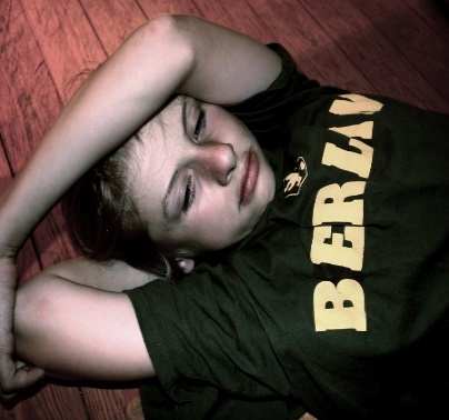 a boy laying on the floor looking unhappy