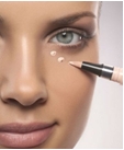 a woman putting makeup on