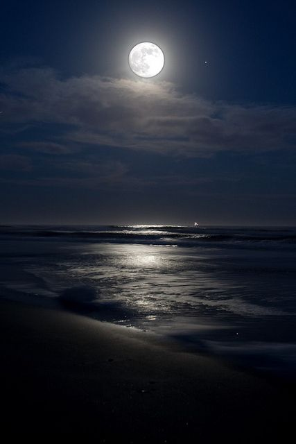 the moon over the ocean at night