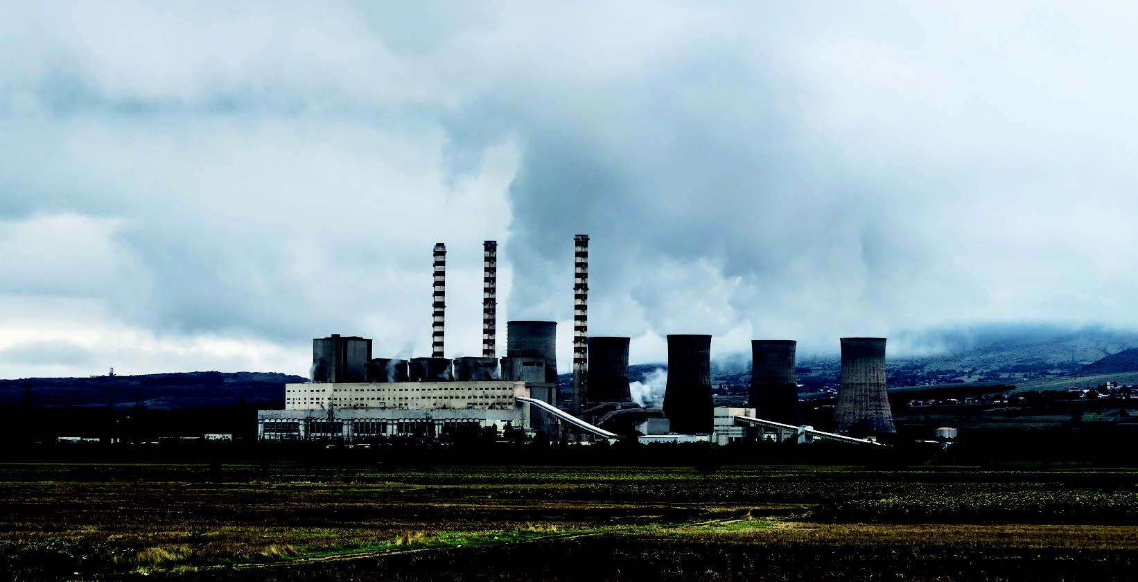 A factory with smoke coming out of it Description automatically generated with low confidence