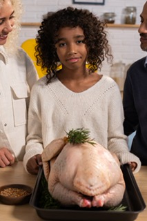 a girl cooking a turkey