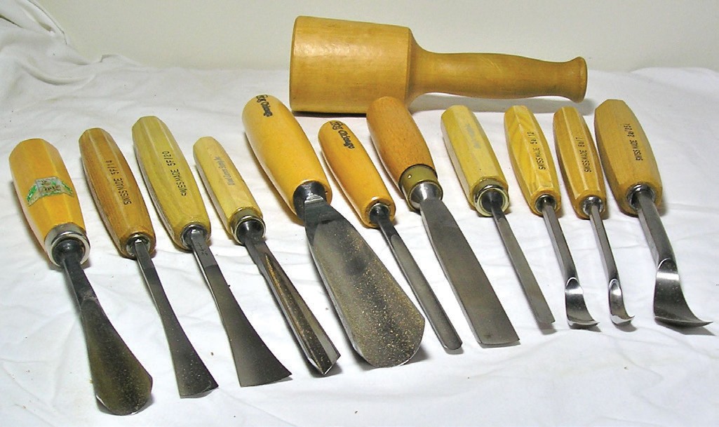 A selection of woodcarving gouges, chisels, and a mallet 