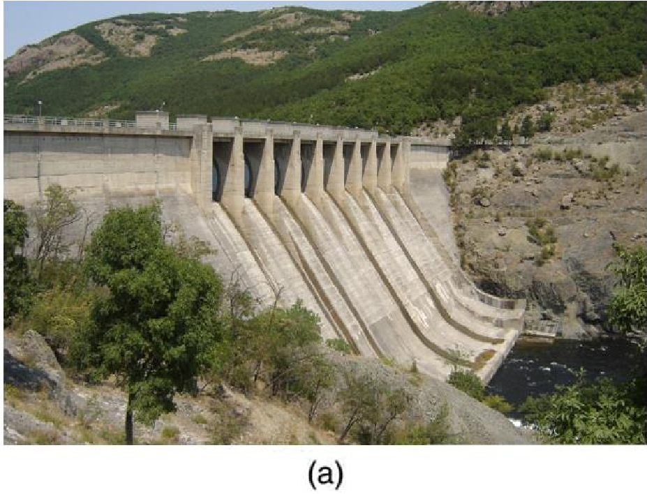 photo of a dam with water rushing from its base
