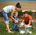 a family washing a dog