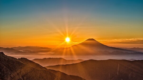 a sunset over mountains