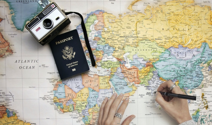 a passport and a camera on a map