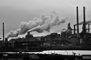 grayscale-photography-of-locomotive-train-beside-factory