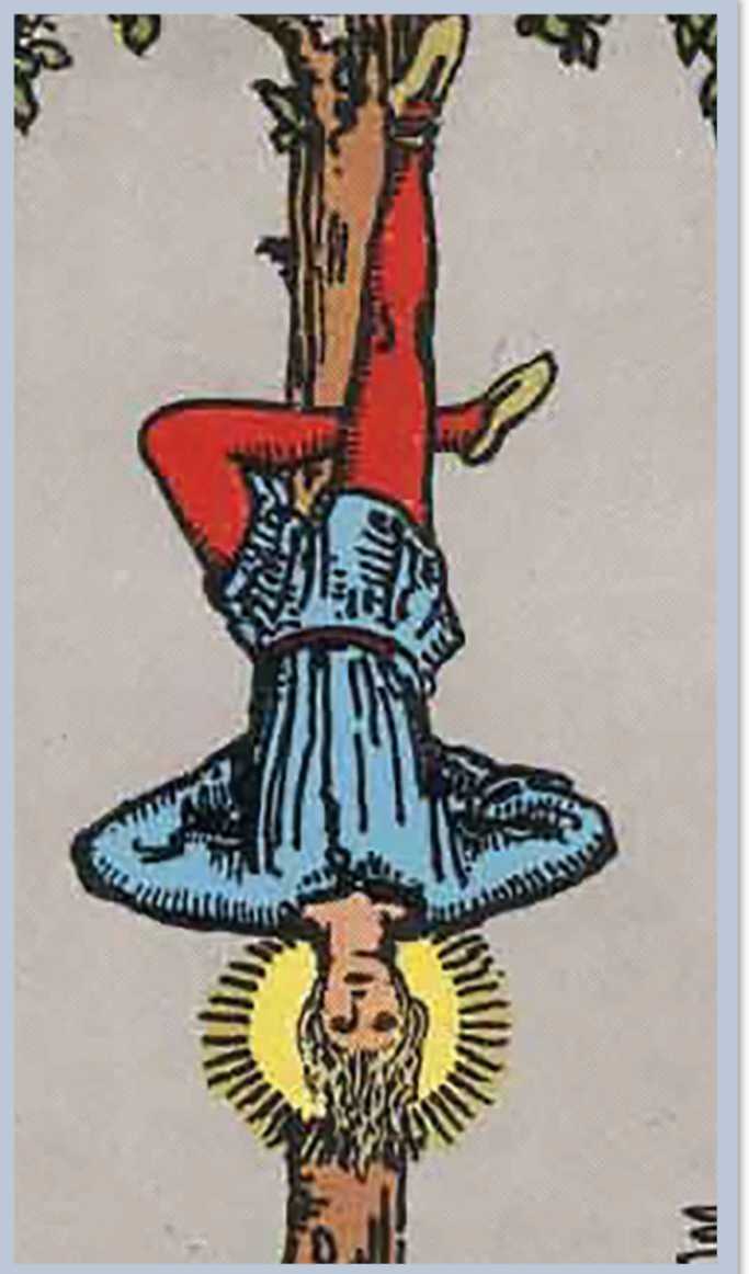 A man upside down hanging by a rope tied around his ankle.