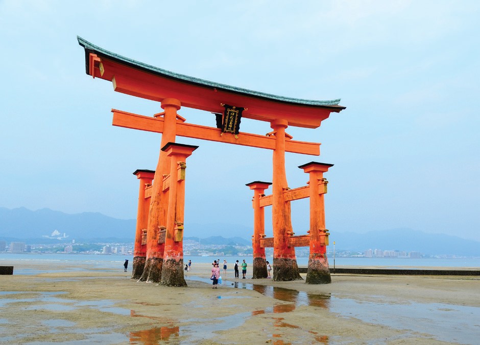 The torii gate at Itsukushima Shrine on the island of Itsukushima at low tide 