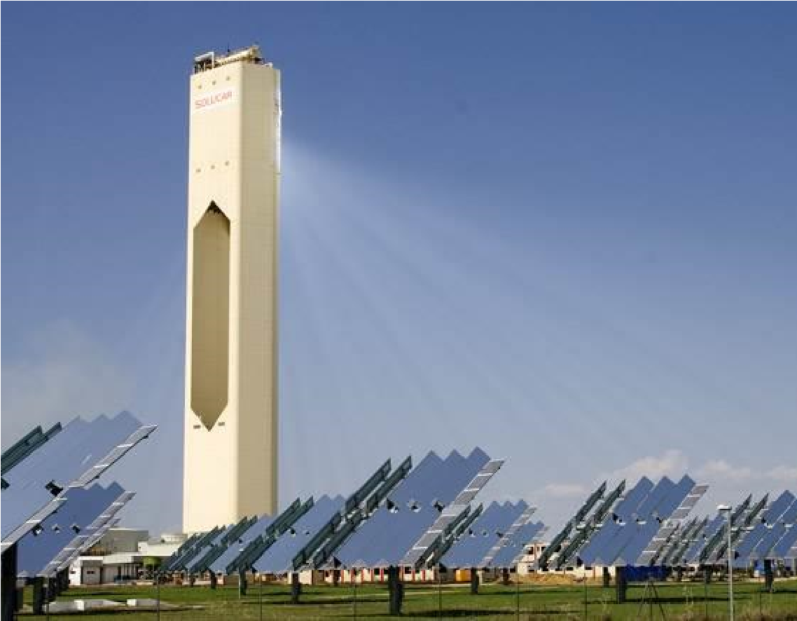 photo of solar power arrays reflecting light onto a tall solar power tower