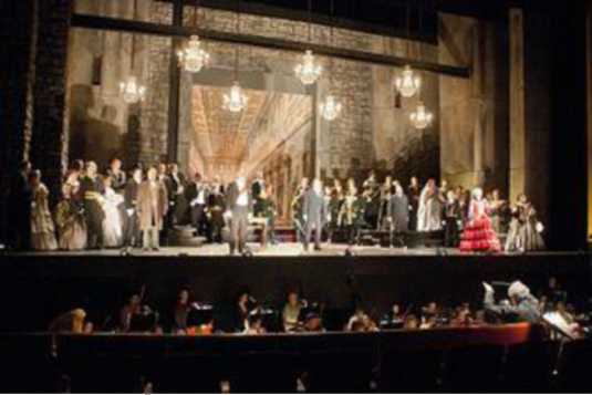 A crowd of people on stage perform.