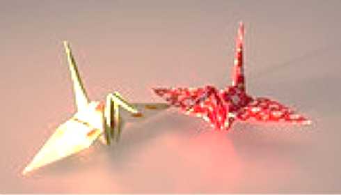 Origami cranes made out of red and yellow paper.