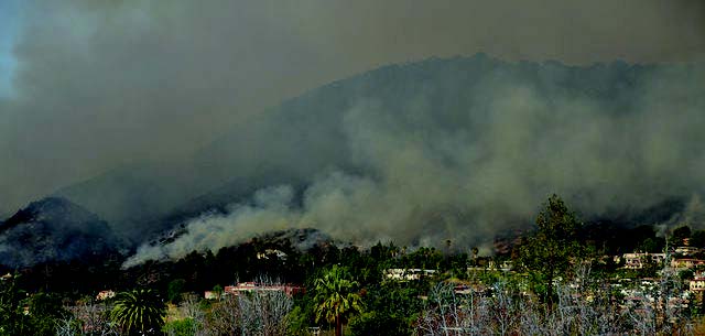 A picture containing smoke, grass, outdoor, nature Description automatically generated