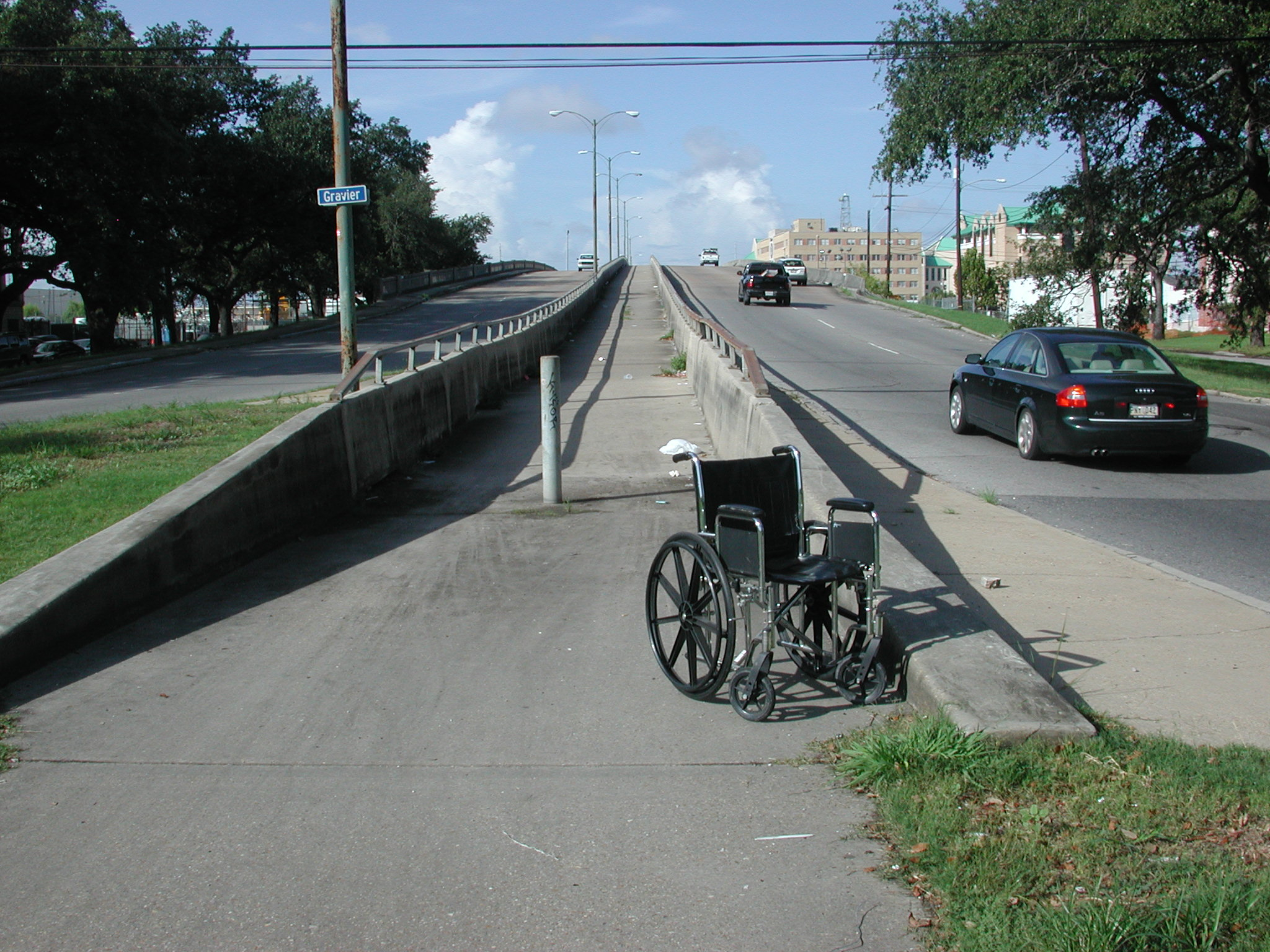An empty wheelchair at an inaccessible curb.